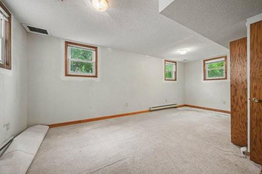 High ceilings make this lower level bedroom feel massive
