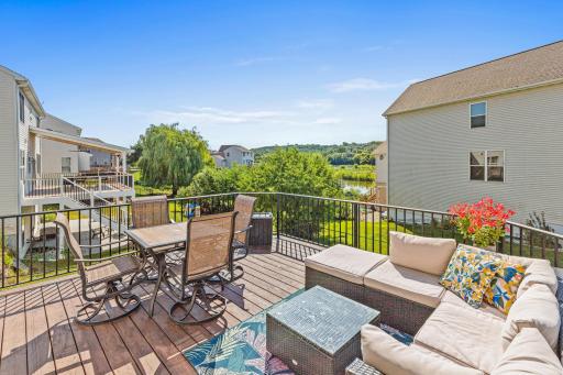 Step outside from the dining area to the large deck overlooking the pond and surrounding green space