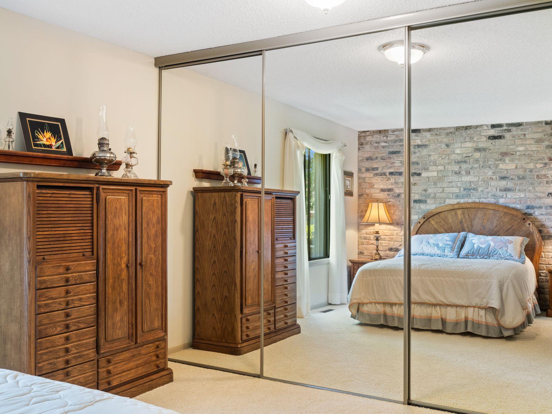 Spacious closet in primary bedroom has built-in closet organizers.
