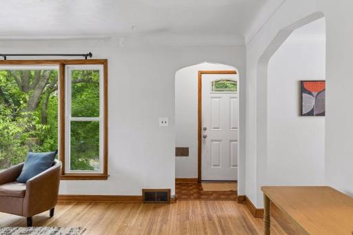 Just inside are arched doorways, hardwood flooring, new windows and the spacious rooms!