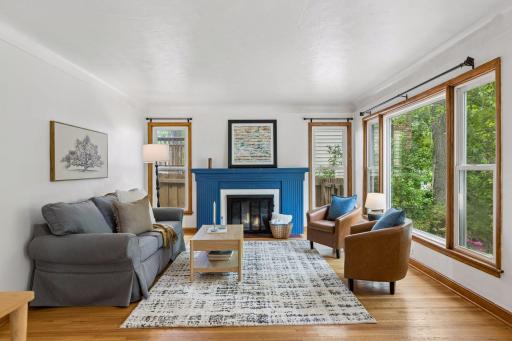 Spacious living room with wood burning fireplace, hardwood flooring!!