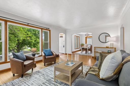 View towards front entry and Dining room. Gorgeous arched doorways! Up above the street are lovely tree top views.