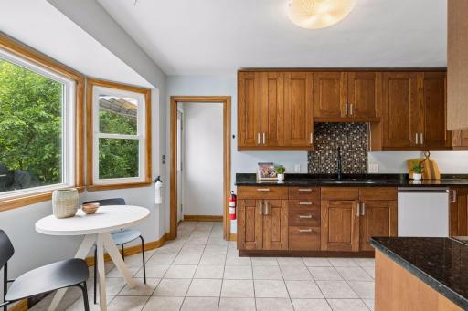Step into this stylishly updated kitchen with stylish wood cabinets, stone countertops, satin nickel hardware and newer appliances!!