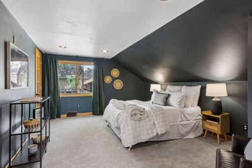 Spacious Primary Bedroom with newer windows, fresh painted walls, new carpeting and walk-in closet behind French doors!!