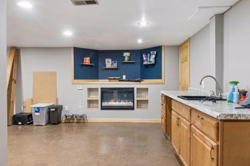 Lower level family room with bar, fireplace and space for a big screen TV to watch the game!