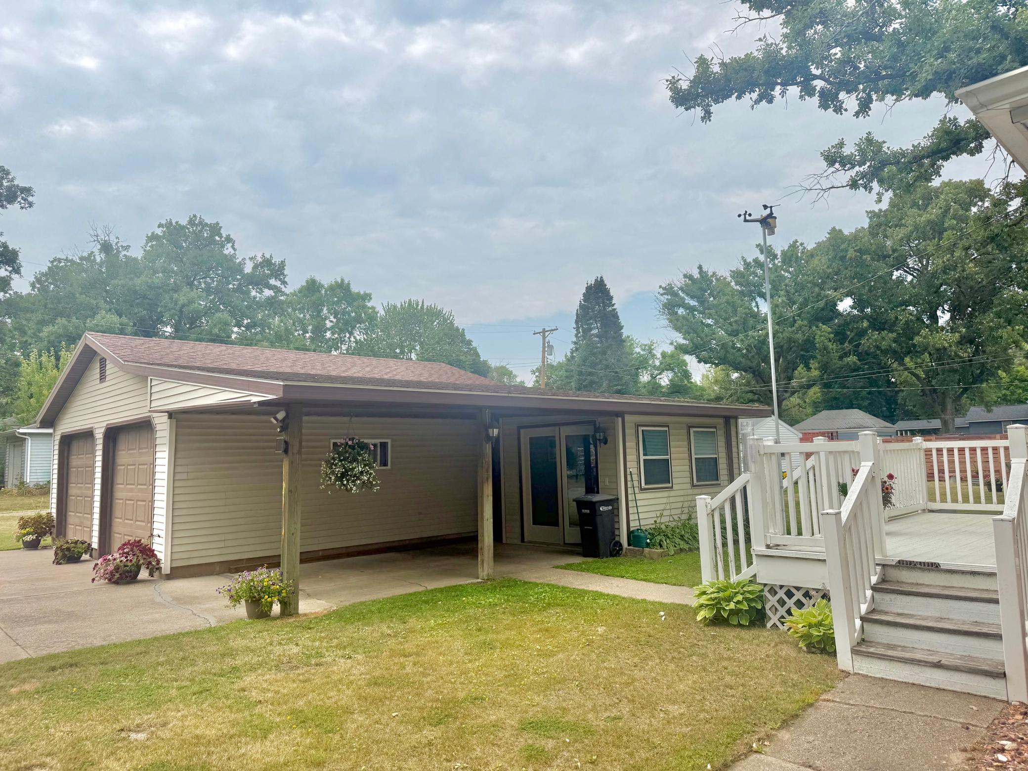 2-Oversized 2 car garage with carport and storage room.jpeg