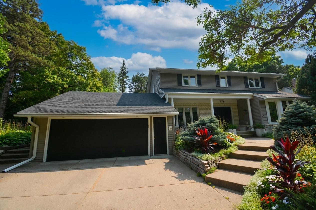 Welcome to 776 Upper Colonial Drive featuring a distinctive covered entry, attached garage, mature landscaping, and exceptional curb appeal.