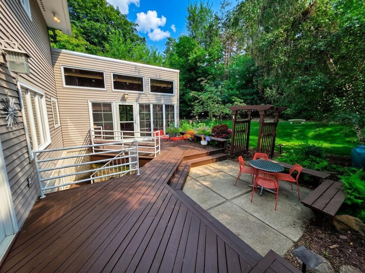 Expansive multi-level deck and patio provide multiple spaces for outdoor dining, entertaining, and relaxing while overlooking the beautifully landscaped backyard.