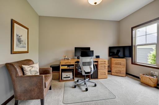 Bright and spacious office off the entry with double doors