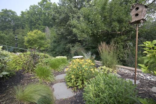 Steps with a railng take you to the lower level of landscaping