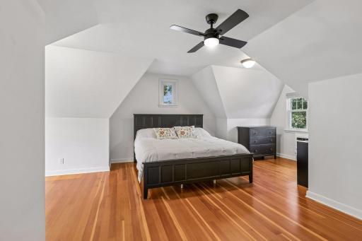 The owners suite spans the entire half story and features a sitting area, vaulted ceiling with new fan, custom built closet and gleaming hardwood floors.