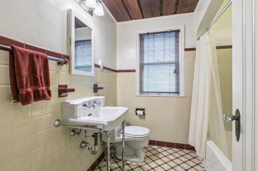 Main floor full bath! Vintage bath in excellent condition with unique wood ceiling.
