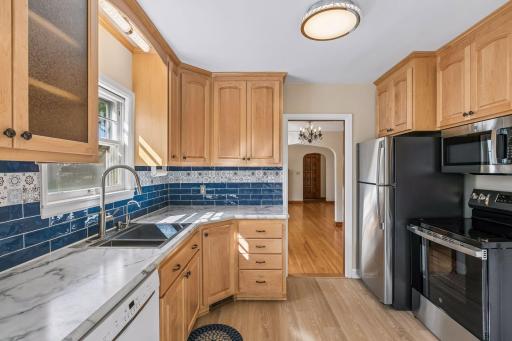 Kitchen was updated in 2021 with refaced cabinetry on solid oak cabinets, (with new custom cabinets above the refrigerator and stove) subway tile backsplash, countertop and sink. BRAND NEW stainless steel appliances and LVP flooring!