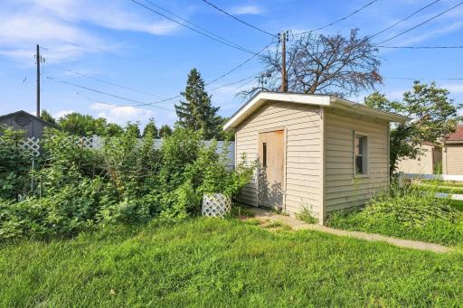 Shed for extra storage and heirloom raspberry bushes