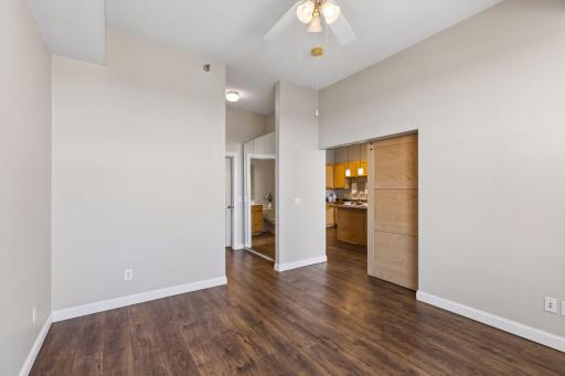 View from the bedroom, with sliding doors and walkthrough access to the walk-in closet and full bathroom.