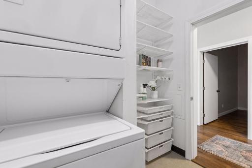 Floor to ceiling storage shelves in laundry room.