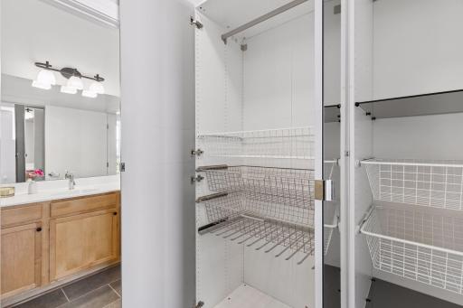 View inside the closet cabinets, with hanging rods and pull out drawers, to keep clothes organized.