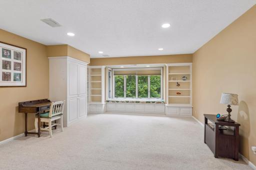 Peaceful window seat with built in cabinetry