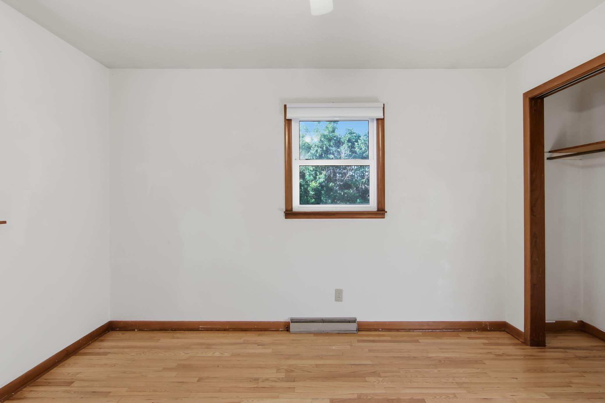 Main Level Bedroom 1 with hardwood flooring