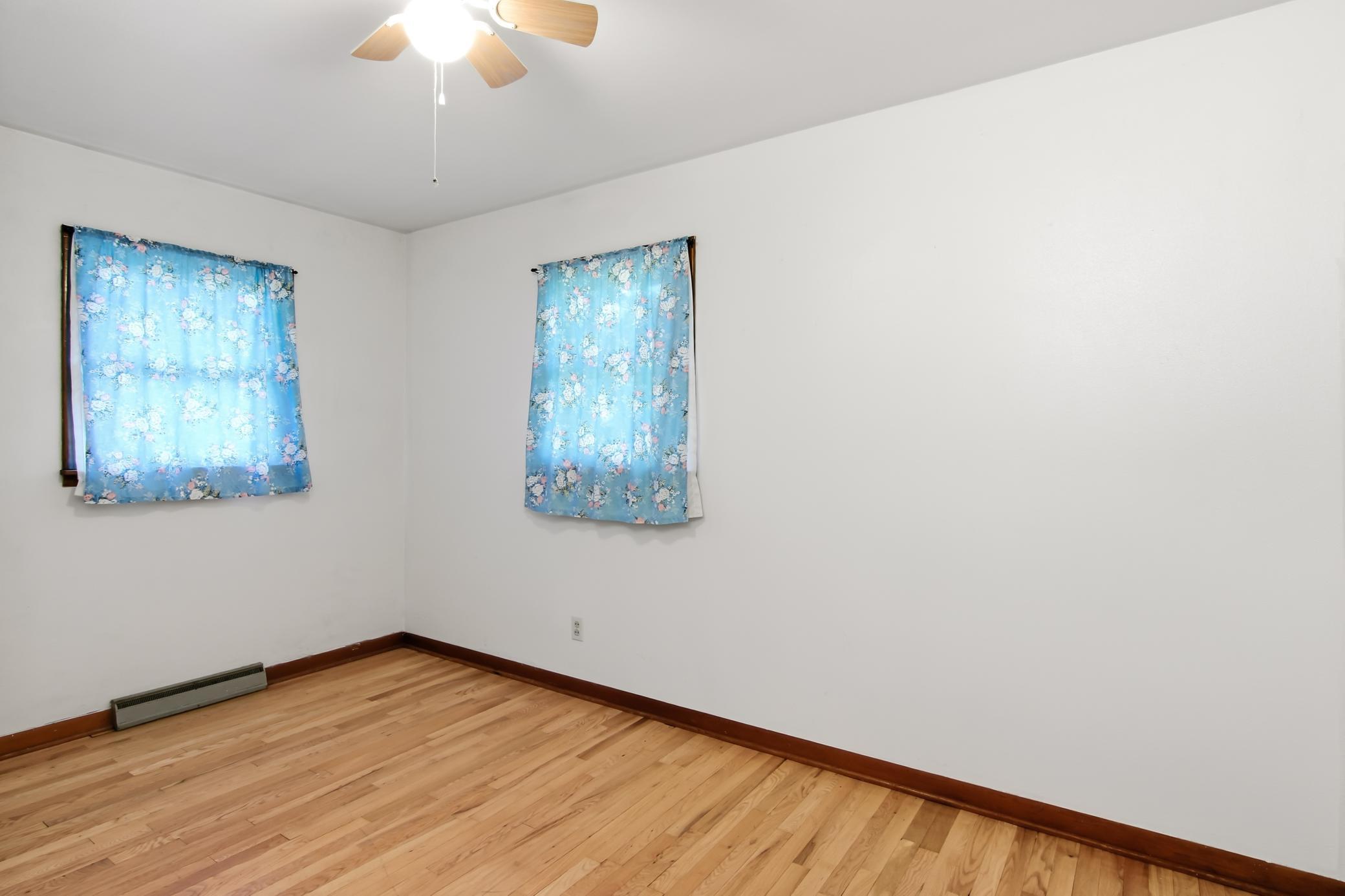 Main Level Bedroom 2 with hardwood flooring