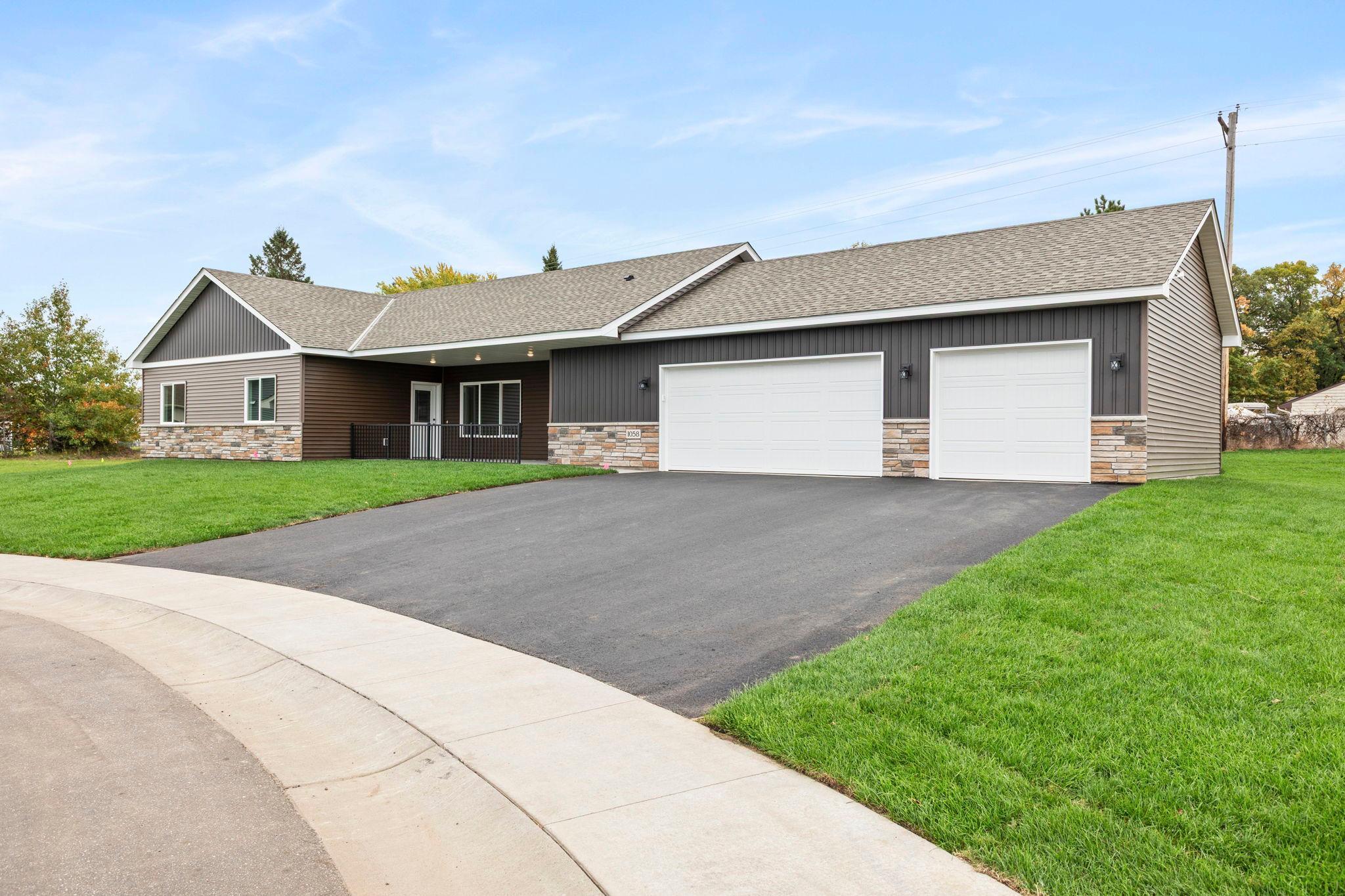 Plenty of parking - 3 car garage and large asphalt driveway