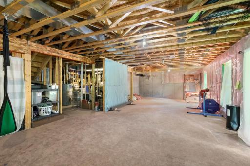Vast walk-out basement featuring exposed framing, high ceilings, ready for your custom finishes—ideal for adding a future family room, extra bedrooms, or a home gym.