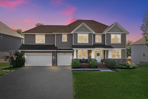 Photo for 3605 Turner Drive SW, Prior Lake, MN 55372 - listing #7127422 Beautiful two-story home showcased at dusk, featuring attractive gray siding, stone accents, multiple gables, and a spacious three-car garage.