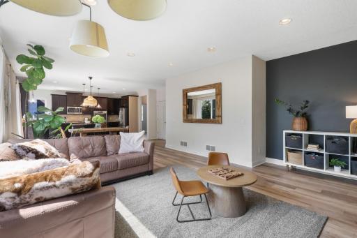 Another view of the open-concept layout showing the seamless transition from the spacious family room into the dining area and chef's kitchen.
