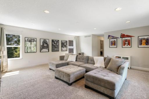 An impressive view showing the true scale of this bright and spacious upper-level bonus room. Offers ample room for large sectional seating, entertainment setups, or a dedicated play/recreation area.