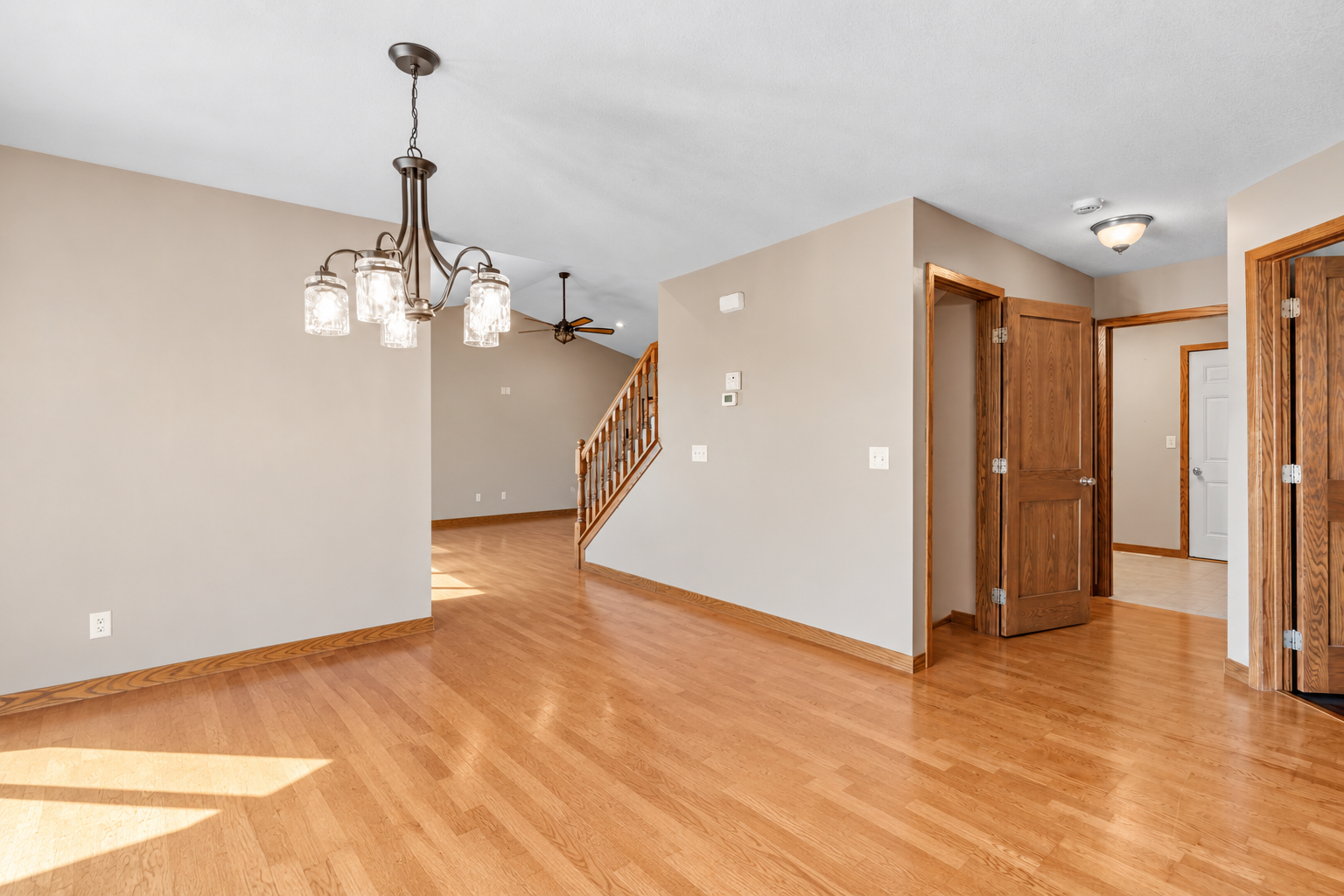 Open dining area with hardwood floors and easy flow to the kitchen and living spaces