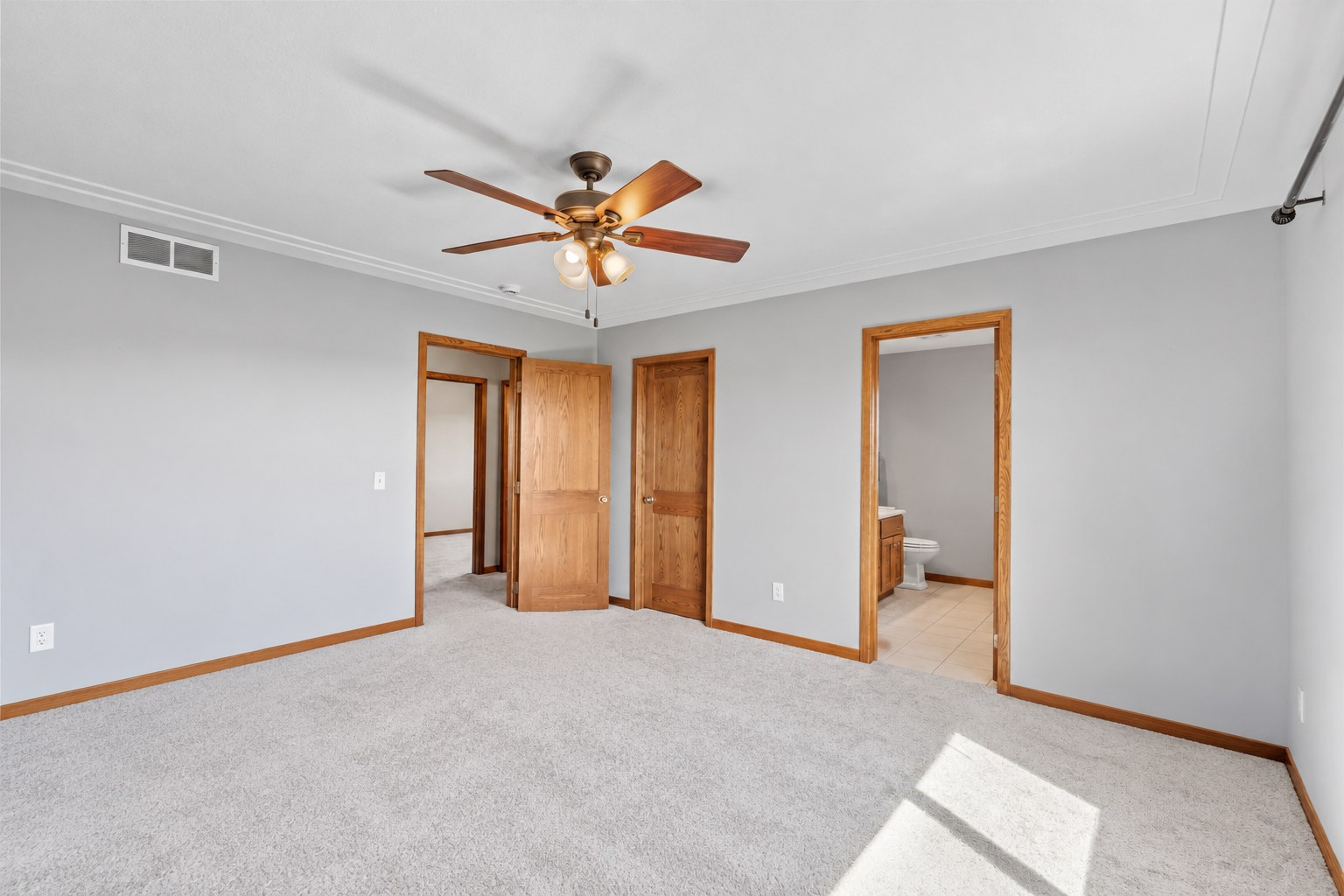 Spacious primary bedroom with private access to the full en-suite bath