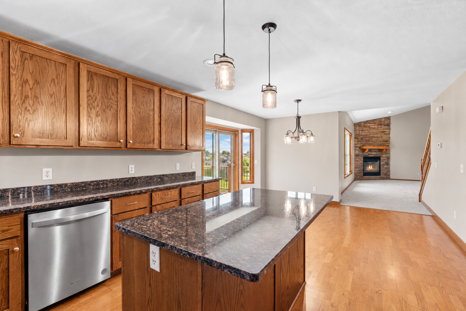 Spacious kitchen with abundant cabinetry, expansive counters, stainless steel appliances and center island