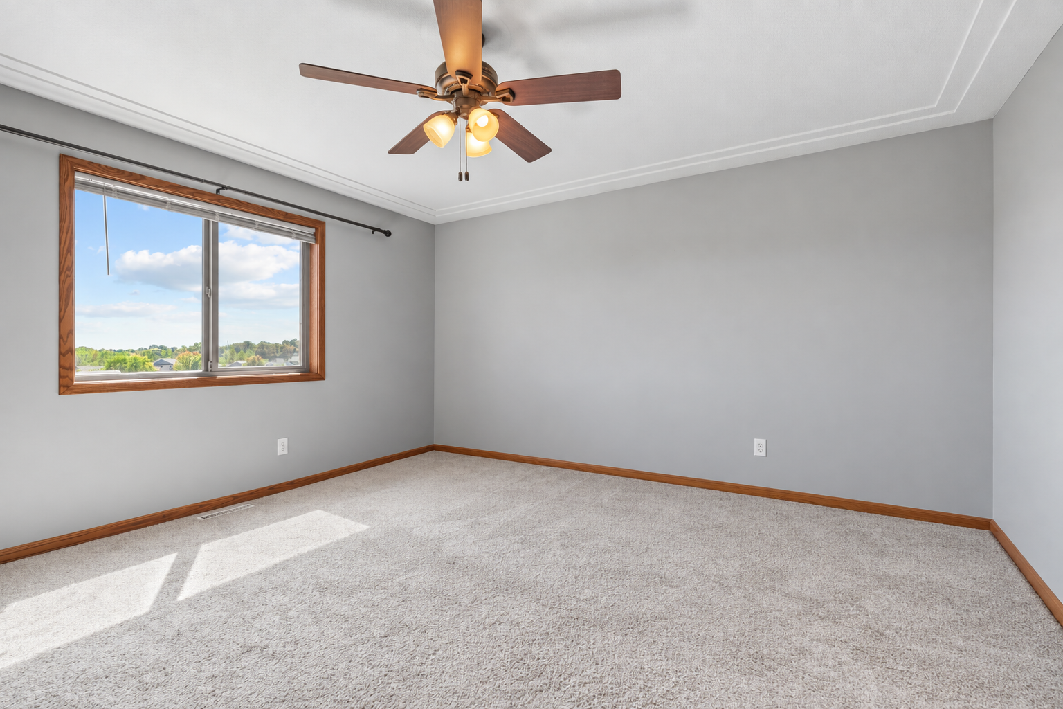 Light-filled primary bedroom with a large window and plenty of room to create a comfortable retreat
