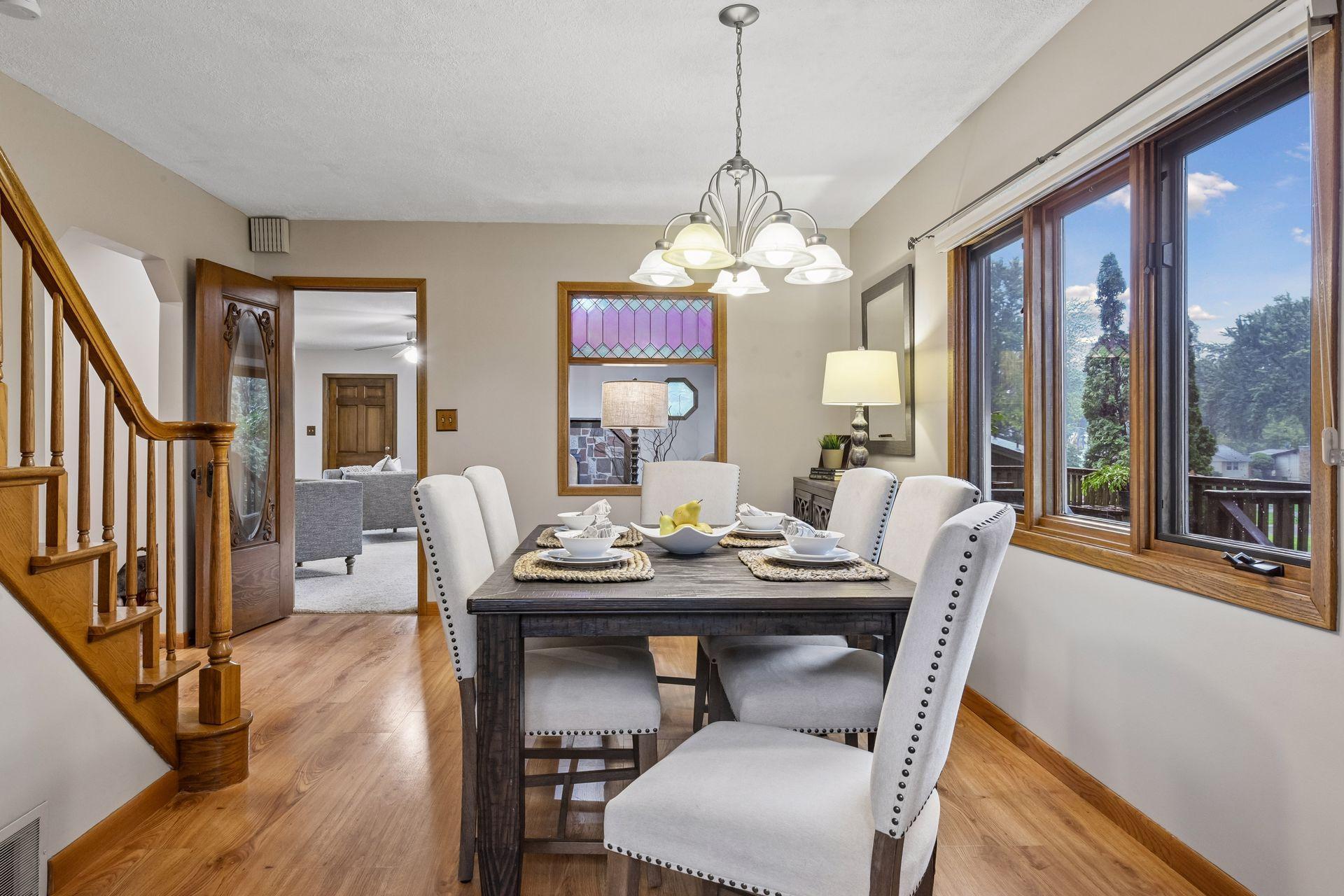 The home offers charming architectural details, including a stained-glass window and an original farmhouse door.