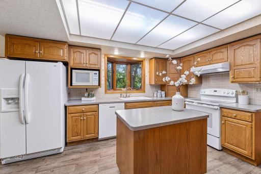 The Kitchen features LVP flooring and an island that is the perfect workspace for whipping up delicious meals.