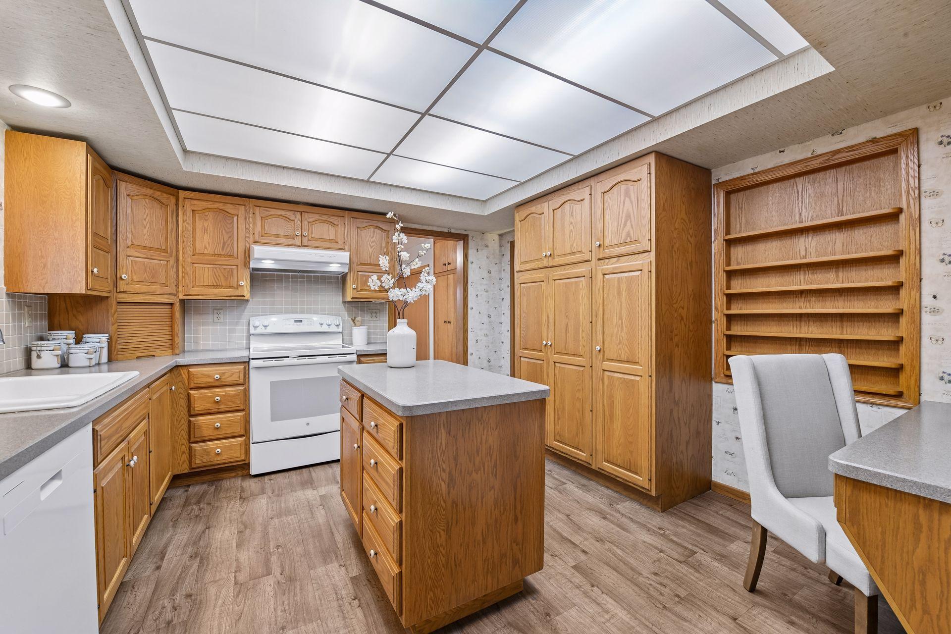 The Kitchen features extensive custom cabinetry including a pantry cabinet with pull-out shelving.