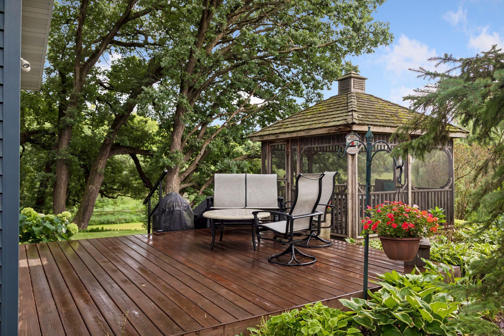 The back deck is nested among the gardens and trees.