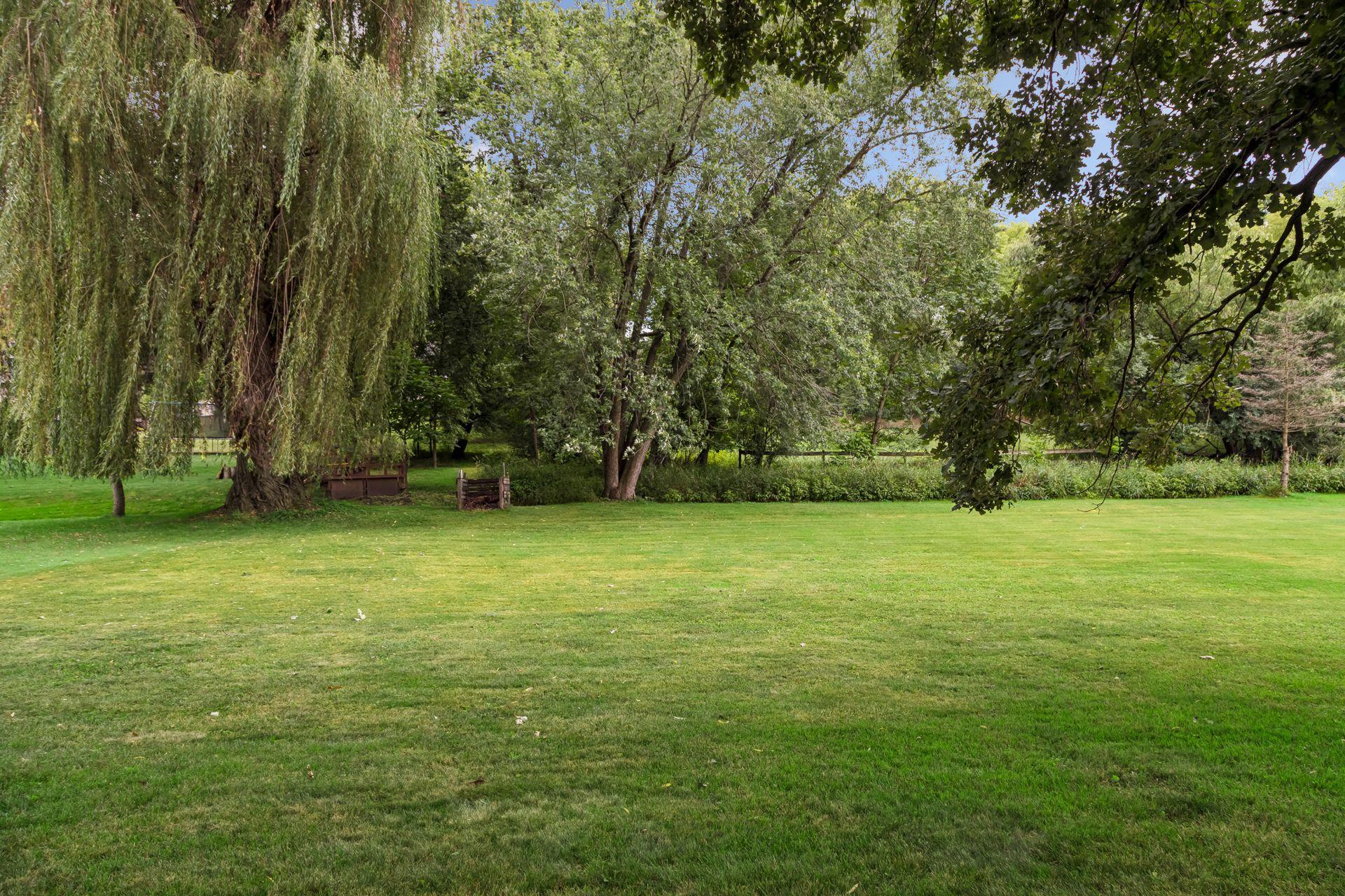 The large, level backyard backs to wetlands and offers mature trees.