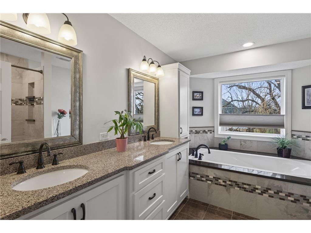 Master bath w/ custom tile, granite and cabinets