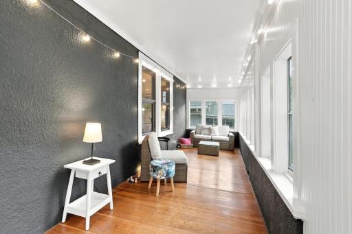 The enclosed front porch is perfect for sipping coffee, feeling the warmth of the sun and a nice breeze, and enjoying slow mornings.