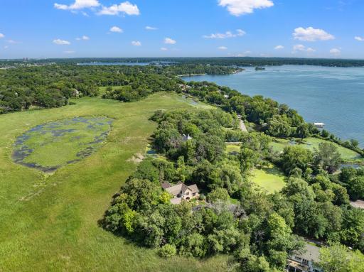 Located on one of Minnesota's most distinguished streets, this 2005 Jyland is tucked beautifully into its 3+ acre, resort-like setting, with 360 degrees of wooded privacy, expansive wetland views.