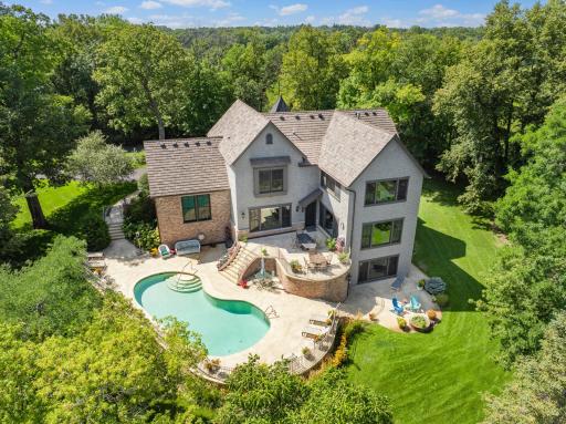 Located on one of Minnesota's most distinguished streets, this 2005 Jyland is tucked beautifully into its 3+ acre, resort-like setting, with 360 degrees of wooded privacy, expansive wetland views.
