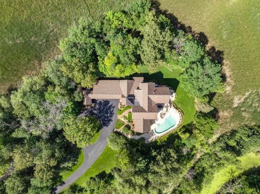 Located on one of Minnesota's most distinguished streets, this 2005 Jyland is tucked beautifully into its 3+ acre, resort-like setting, with 360 degrees of wooded privacy, expansive wetland views.