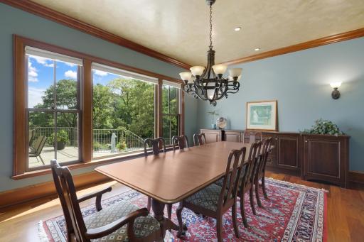 The expansive dining room offers a beautiful setting for entertaining, with picturesque views overlooking the terrace and pool.