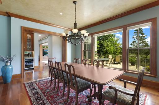The expansive dining room offers a beautiful setting for entertaining, with picturesque views overlooking the terrace and pool.