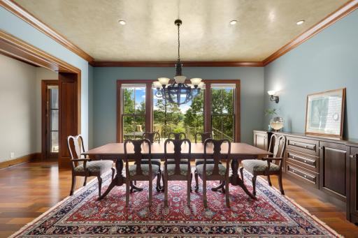 The expansive dining room offers a beautiful setting for entertaining, with picturesque views overlooking the terrace and pool.