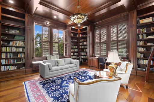 Surrounded by books and bathed in natural light, this inviting library offers built-in window benches and floor-to-ceiling shelving - a quiet place to linger.