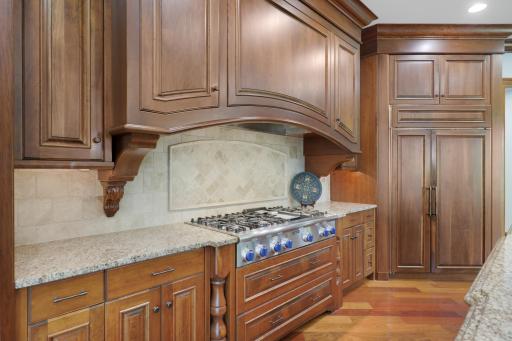 Exceptional function meets timeless design with Sub-Zero and Thermador appliances, a commanding range hood, and a butler’s pantry accented by elegant marble countertops.