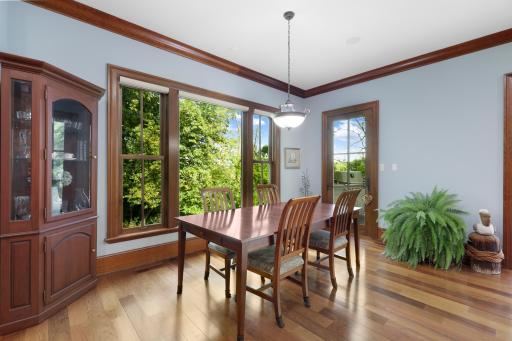 The kitchen opens naturally to the informal dining room and connects directly to a dedicated outdoor grilling area, complete with a Ventulux natural gas grill.