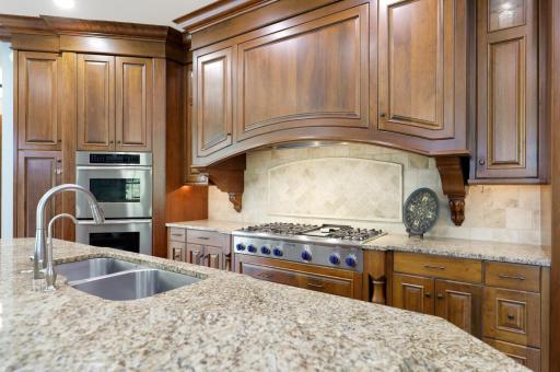Exceptional function meets timeless design with Sub-Zero and Thermador appliances, a commanding range hood, and a butler’s pantry accented by elegant marble countertops.